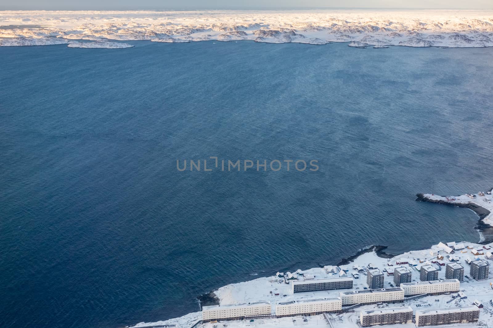 Aerial view to the fjord, Inuit houses and snow street of Greenl by ambeon