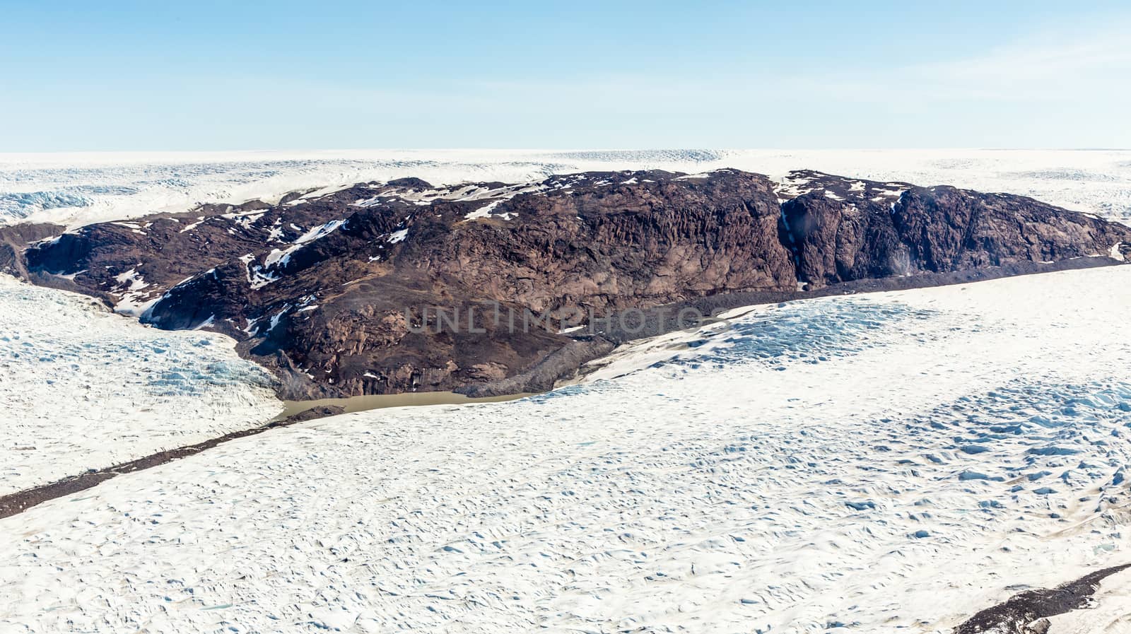 Greenlandic melting ice sheet glacier aerial view from the plane, near Kangerlussuaq, Greenland