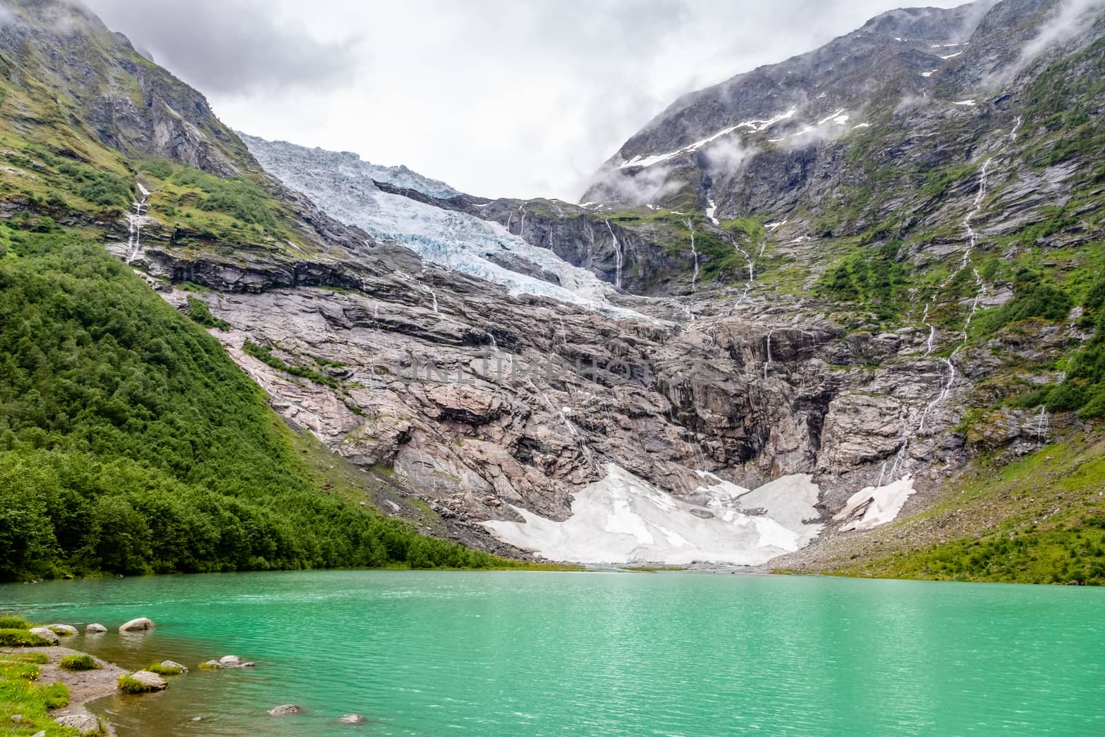Boeyabreen Glacier in the mountains with lake in the foreground, Jostedalsbreen National Park, Fjaerland, Norway