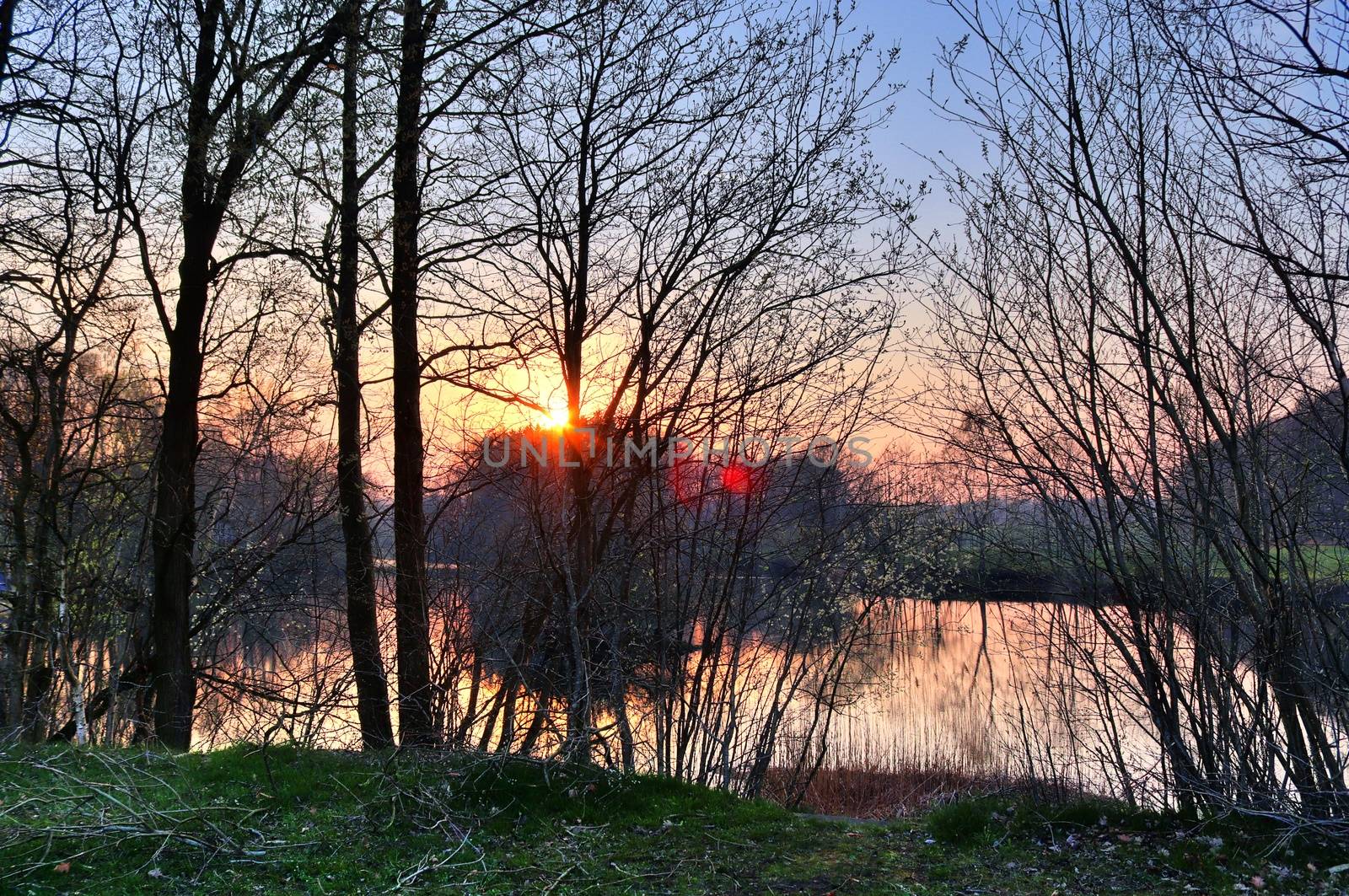 Beautiful and romantic sunset at a lake in stunning yellow and orange colors