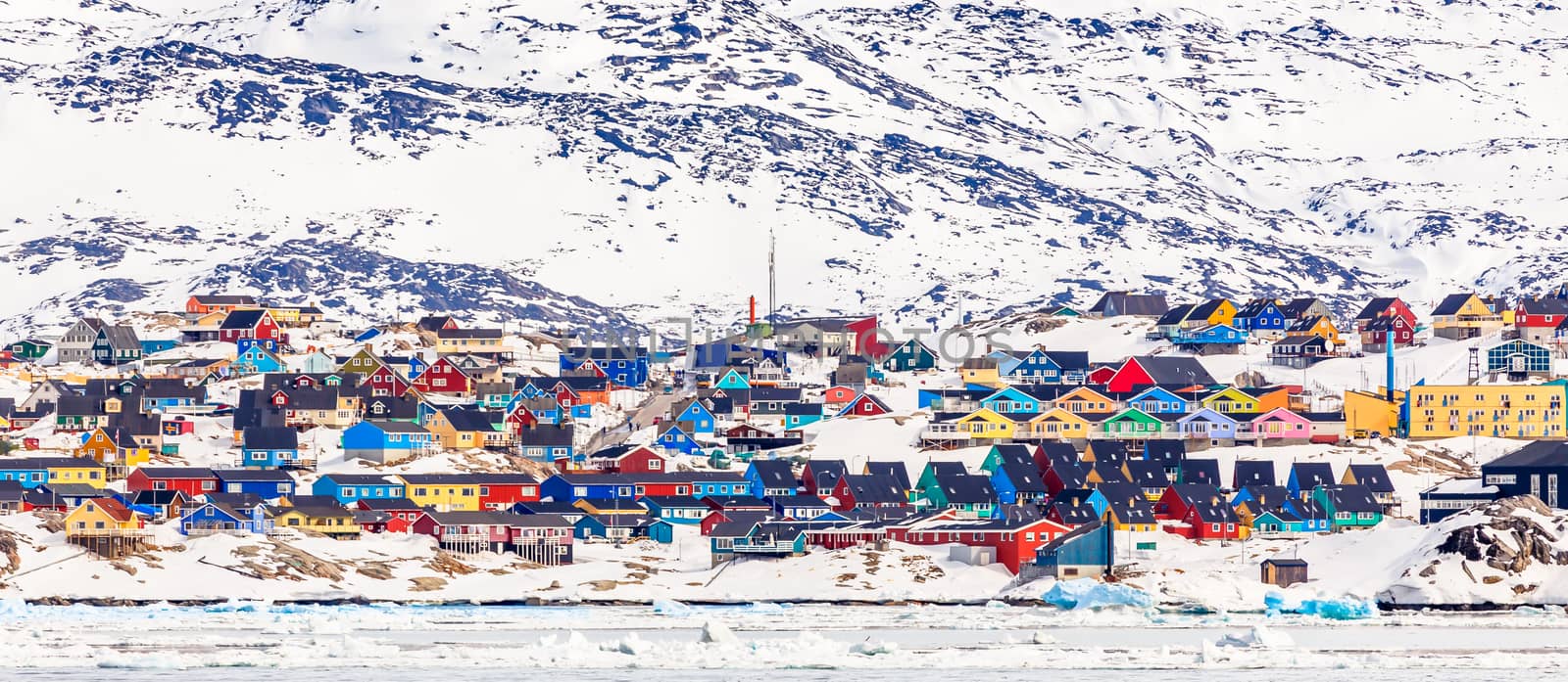 Arctic city center panorama with colorful Inuit houses on the ro by ambeon