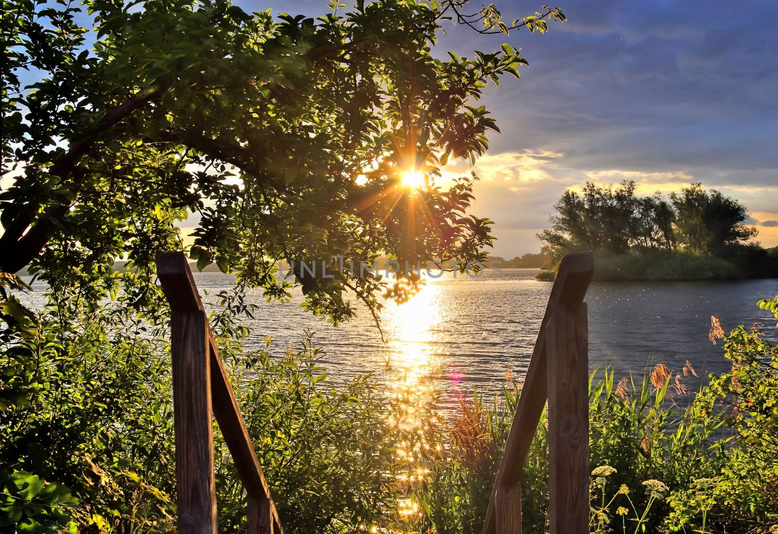 Beautiful and romantic sunset at a lake in stunning yellow and orange colors