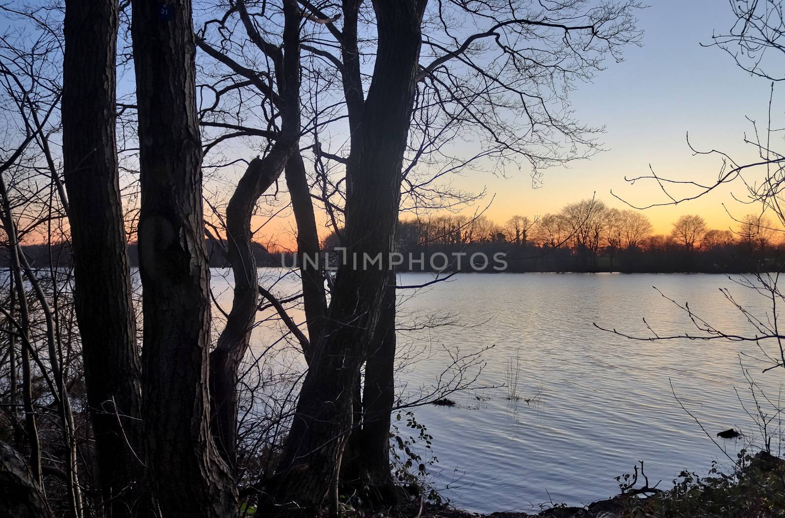 Beautiful and romantic sunset at a lake in stunning yellow and orange colors