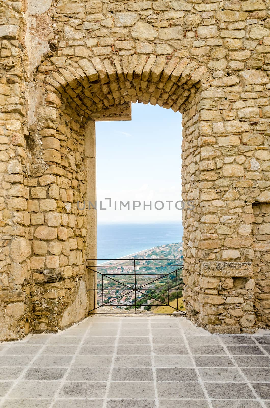 Ancient window among ruins of an old castle with seascape by marcorubino