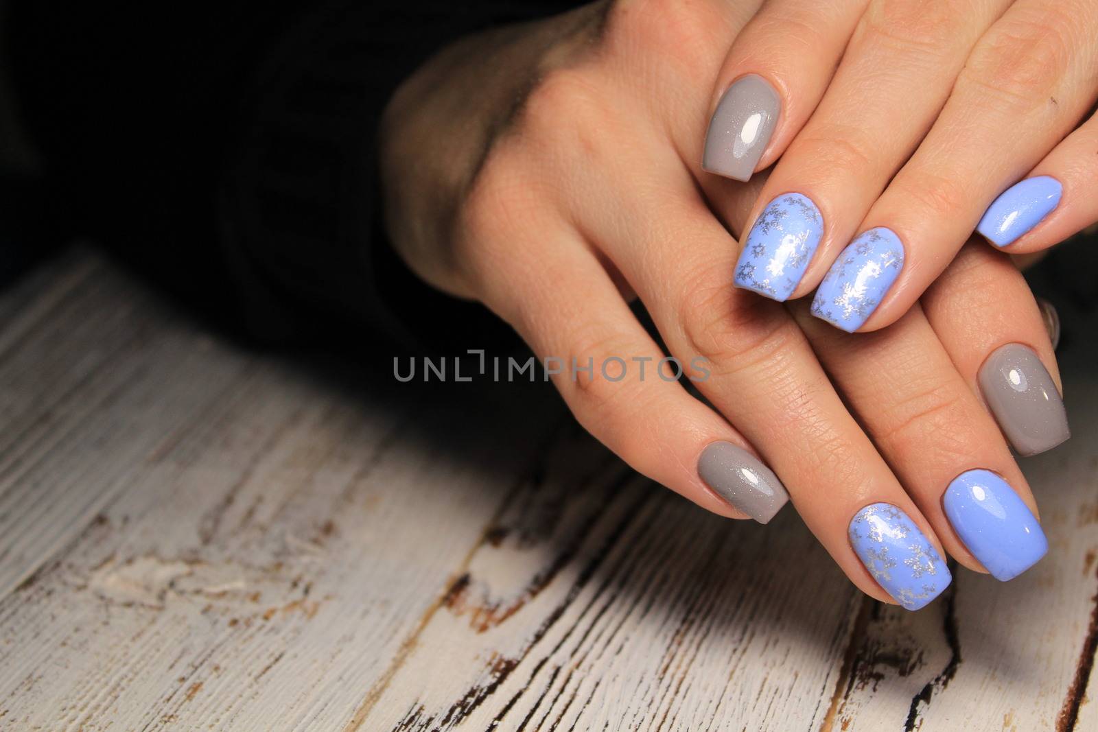 Closeup photo of a beautiful female hands with elegant manicure and diamond rings.