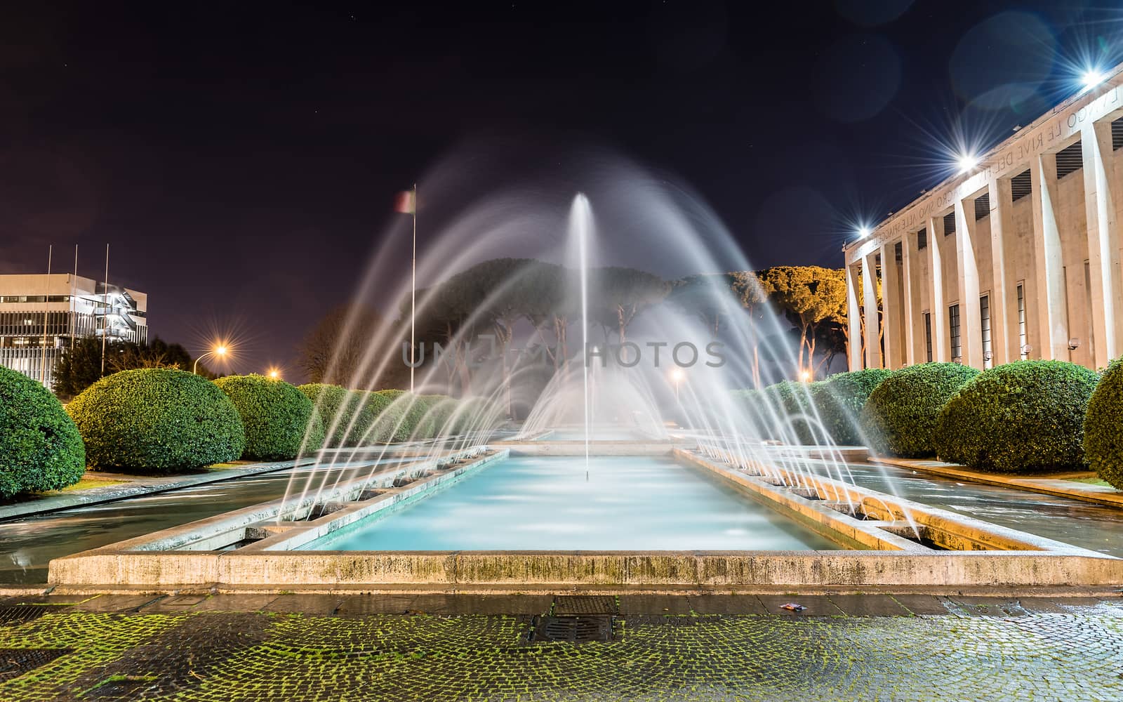Scenic fountain, iconic neoclassical architecture in the EUR district, Rome, Italy