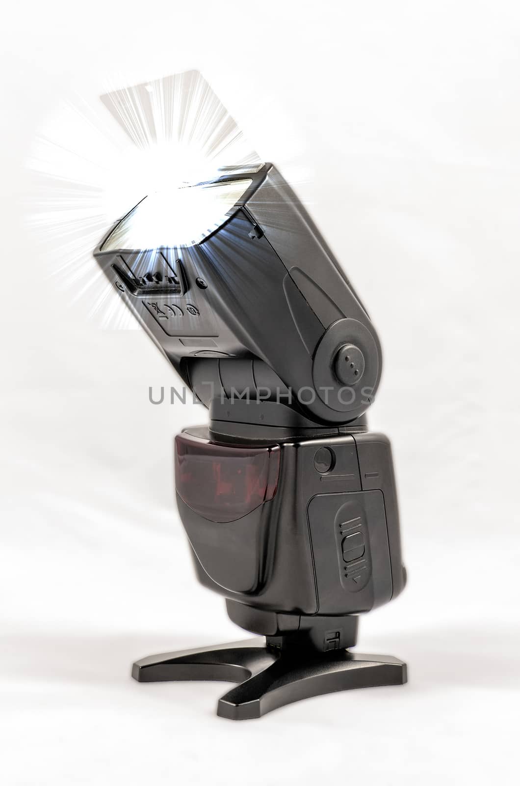 Oblique view of a black unbranded external flash unit for DSLR camera with bounce card extended while shooting