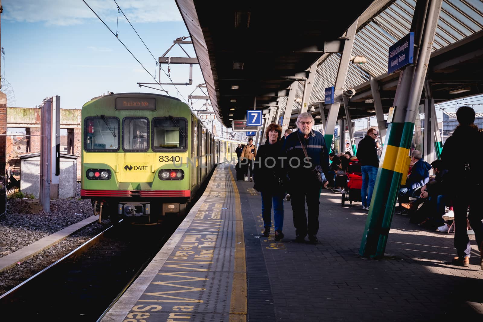 Dublin, Ireland - February 15, 2019: Passengers walking on the platform of Connolly DART train station (Staisiun ui Chonghaile) on a winter day