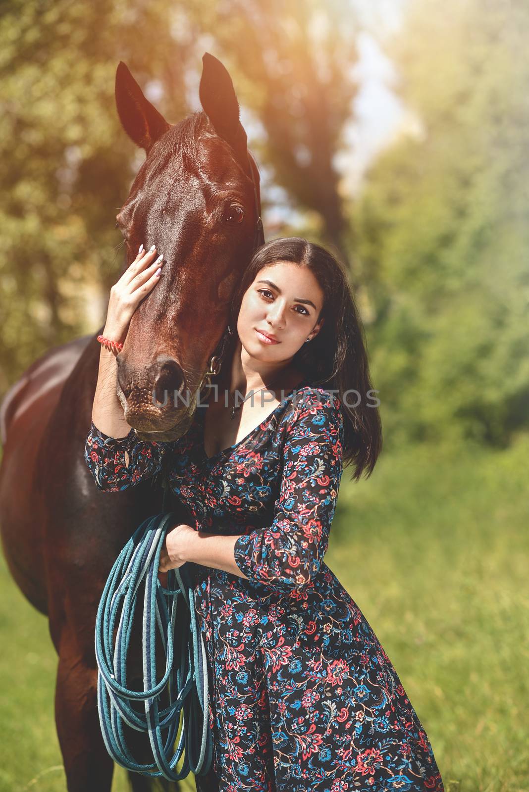 Beautiful Latin woman and her lovely horse walk in the forest. love animals concept