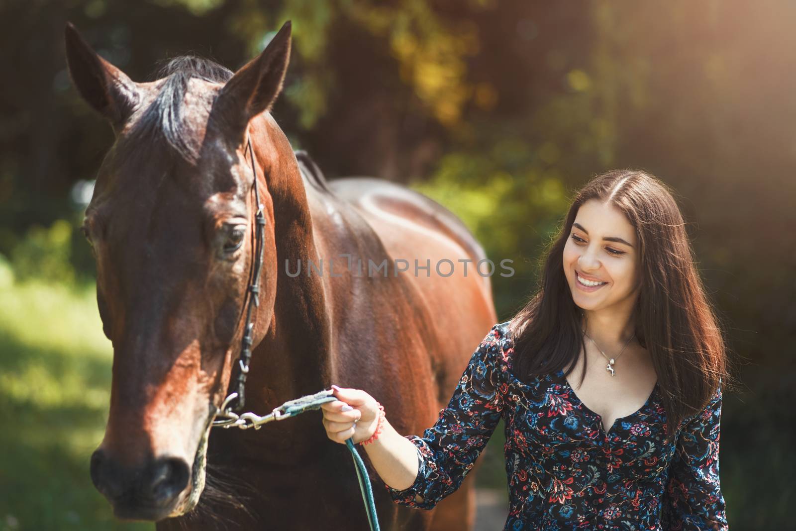 Beautiful Latin woman and her lovely horse walk in the forest. love animals concept