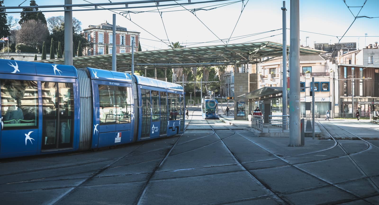 Montpellier, France - January 2, 2019: electric tramway passing the Corum, a convention center and Opera Berlioz on a winter day