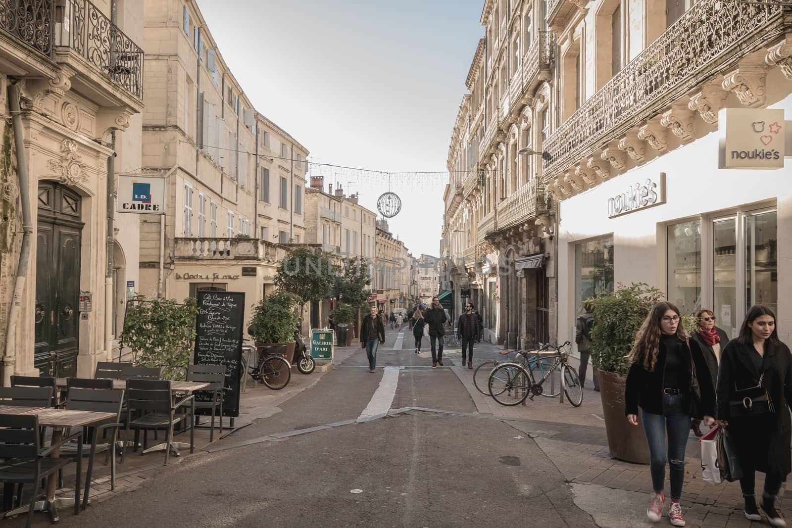 Montpellier, France - January 2, 2019: Street atmosphere and architecture in a shopping street in the historic city center where people walk on a winter day