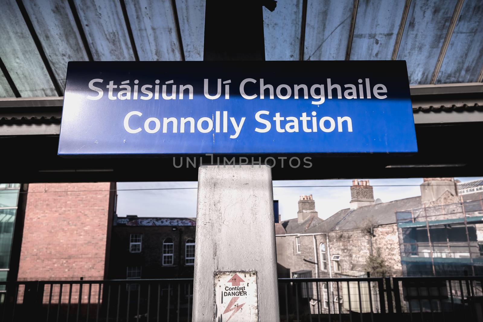 Dublin, Ireland - February 15, 2019: Blue platform sign announcing the name of the station in the Connolly DART train station (Staisiun ui Chonghaile) on a winter day