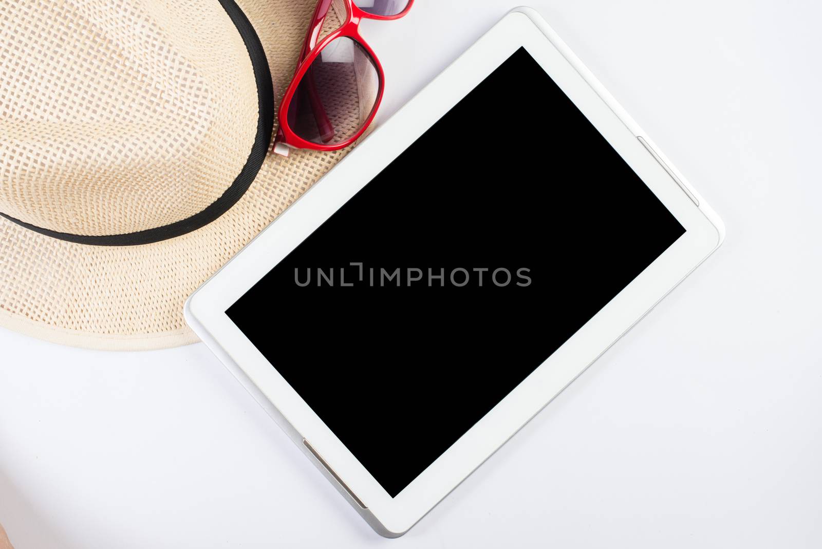 Top view of hat woman glasses and blank screen of tablet device isolated  on white  backgroound.