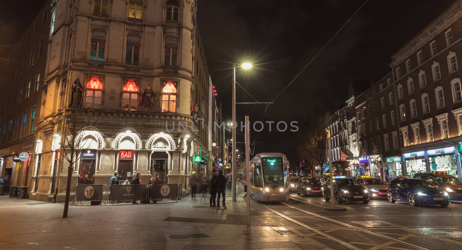 Dublin, Ireland - February 15, 2019: Architecture detail at night of the Wax Museum in the city center where people walk one evening