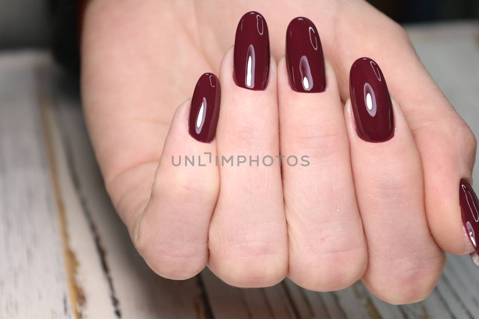 Closeup photo of a beautiful female hands with elegant manicure and diamond rings.