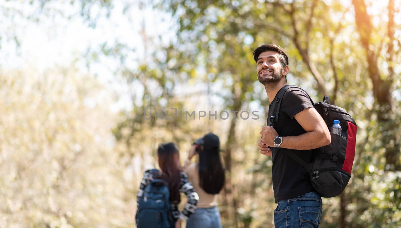 Group of young friends traveler in nature. Happy Bearded Man backpacker on vacation. Copy space.