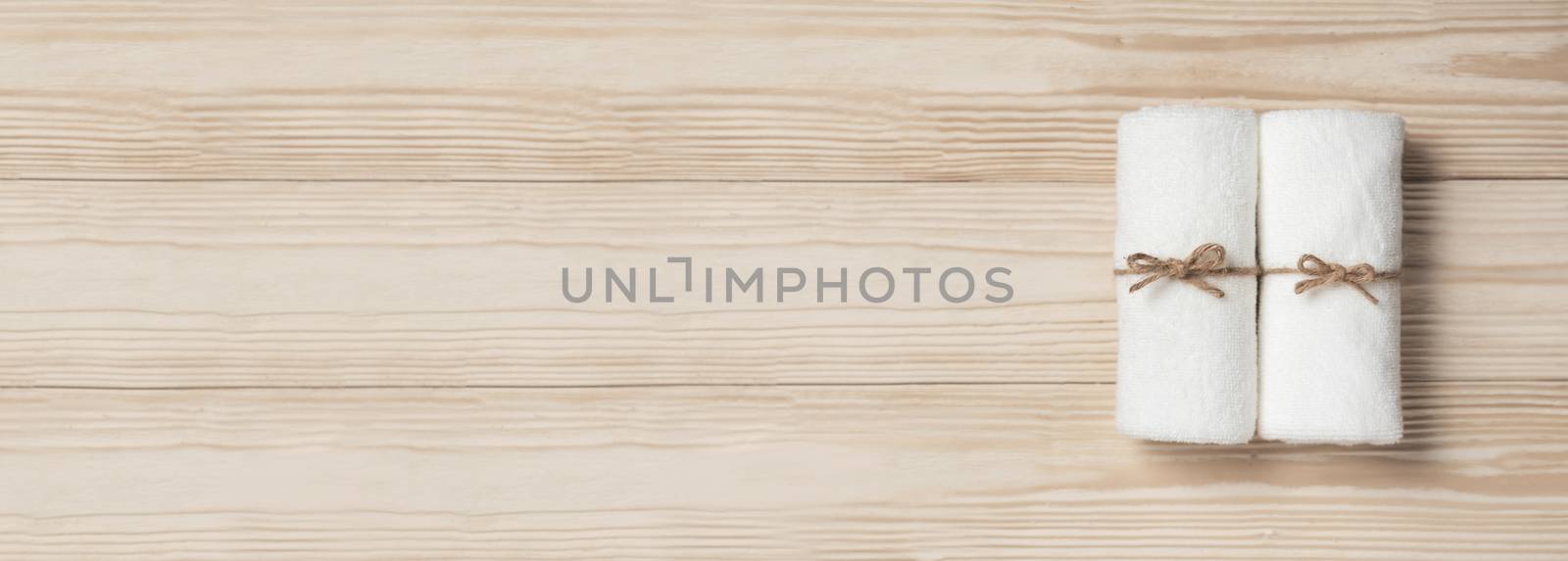 Soft towels on wood background with Copy space. Spa product. banner, panoramic.