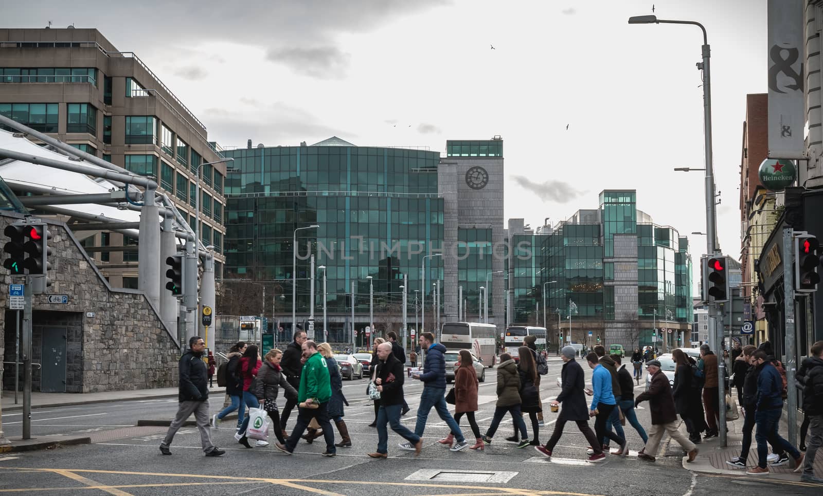 Dublin, Ireland - February 12, 2019: Group of many pedestrians crossing a crosswalk in the city center on a winter day