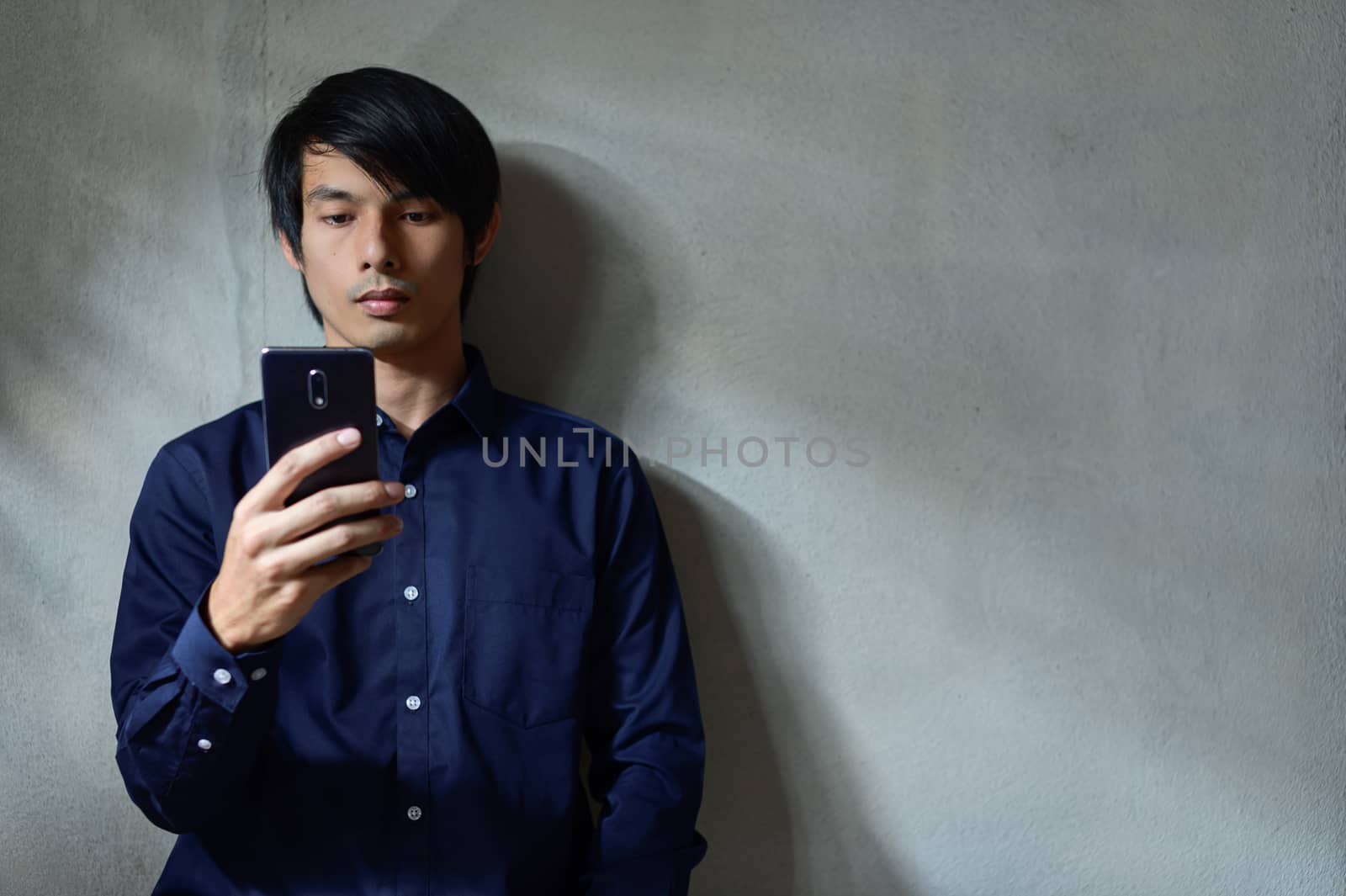 Asian businessmen are using smartphones. by Aukid