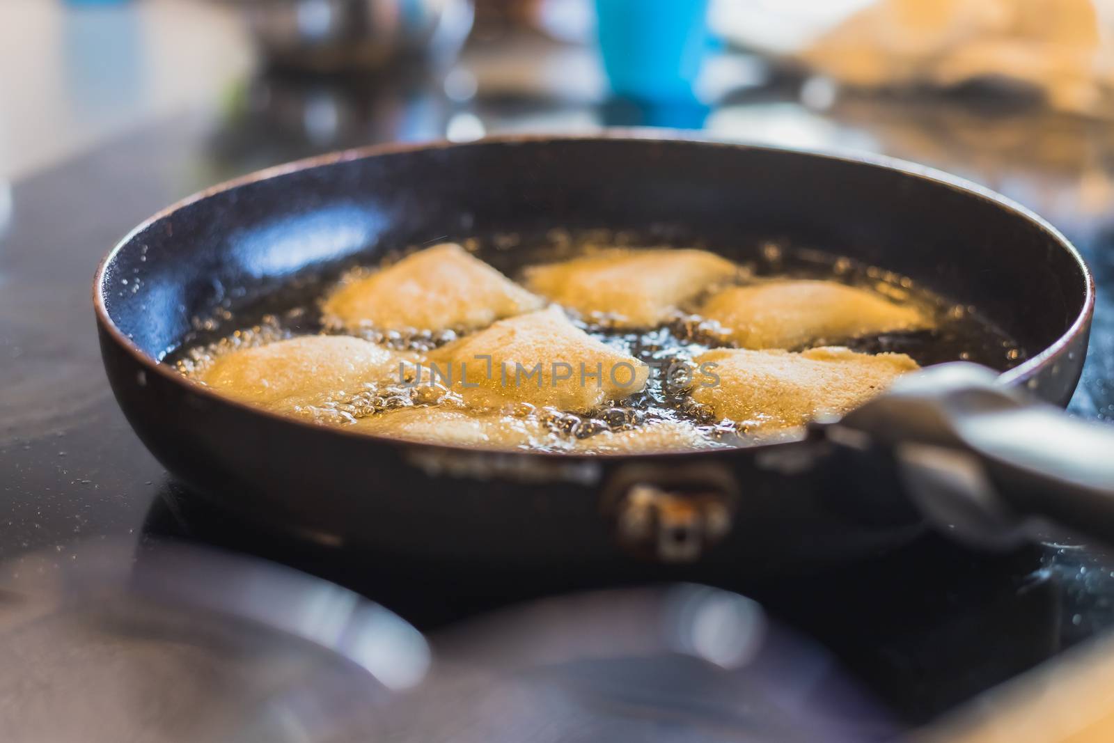 fried Portuguese or Brazilian rissoles in a frying pan by AtlanticEUROSTOXX