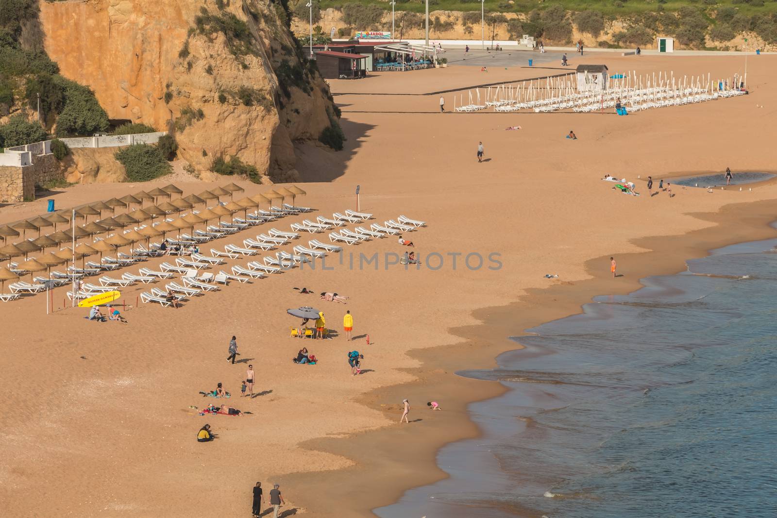 Albufeira, Portugal - May 3, 2018: High view of the city beaches in a very tourist destination in southern Portugal, in the Algarve where people are resting on a spring day