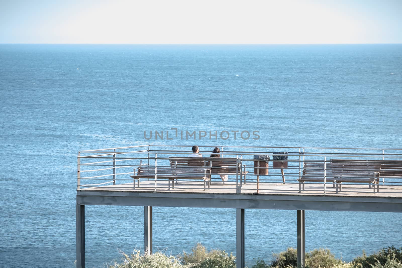 People enjoying the sea view from a pontoon in Albufeira, Portug by AtlanticEUROSTOXX