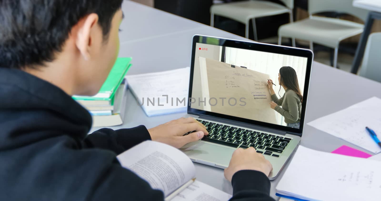 Asian students use notebook and tablet computers to work and study online at home during the coronavirus epidemic and quarantine at home