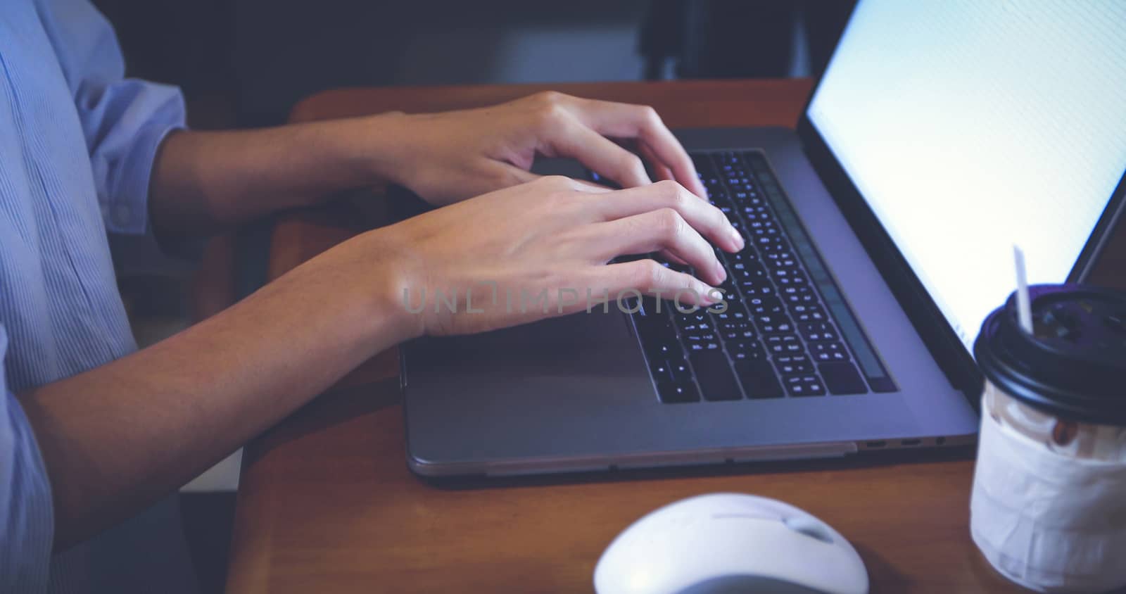 Asian woman is using a notebook computer for work at home and she is quarantine during the coronavirus epidemic.