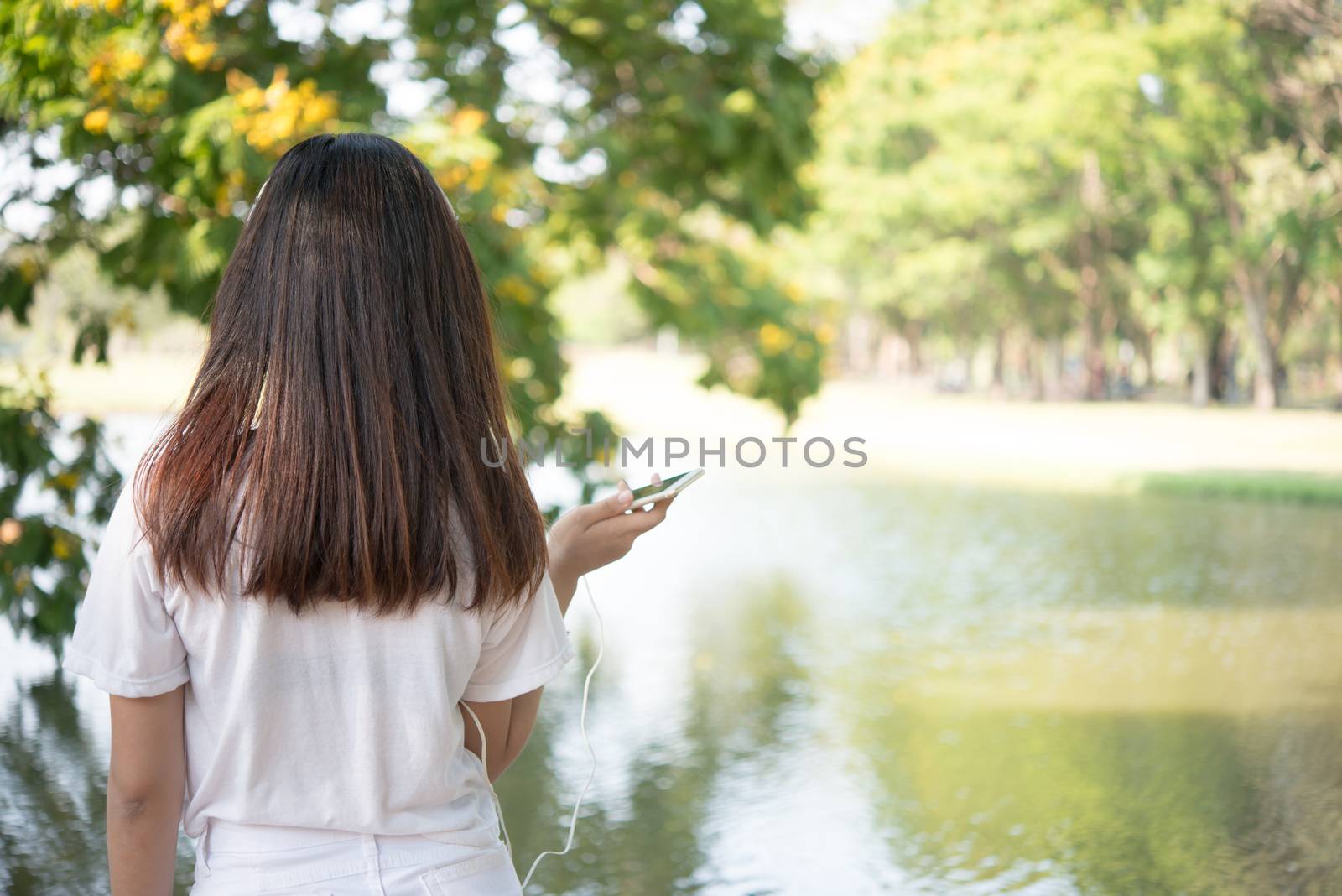 Rear of young woman relaxing at park.