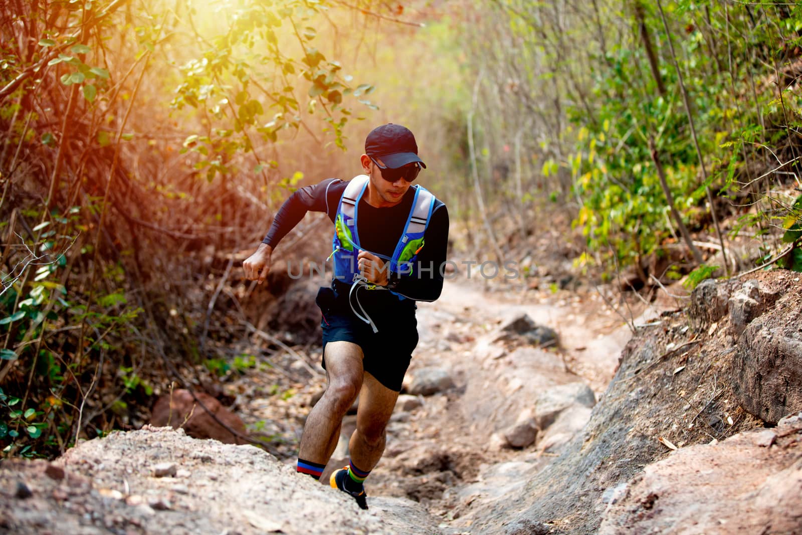 A man Runner of Trail and athlete's feet wearing sports shoes for trail running in the forest