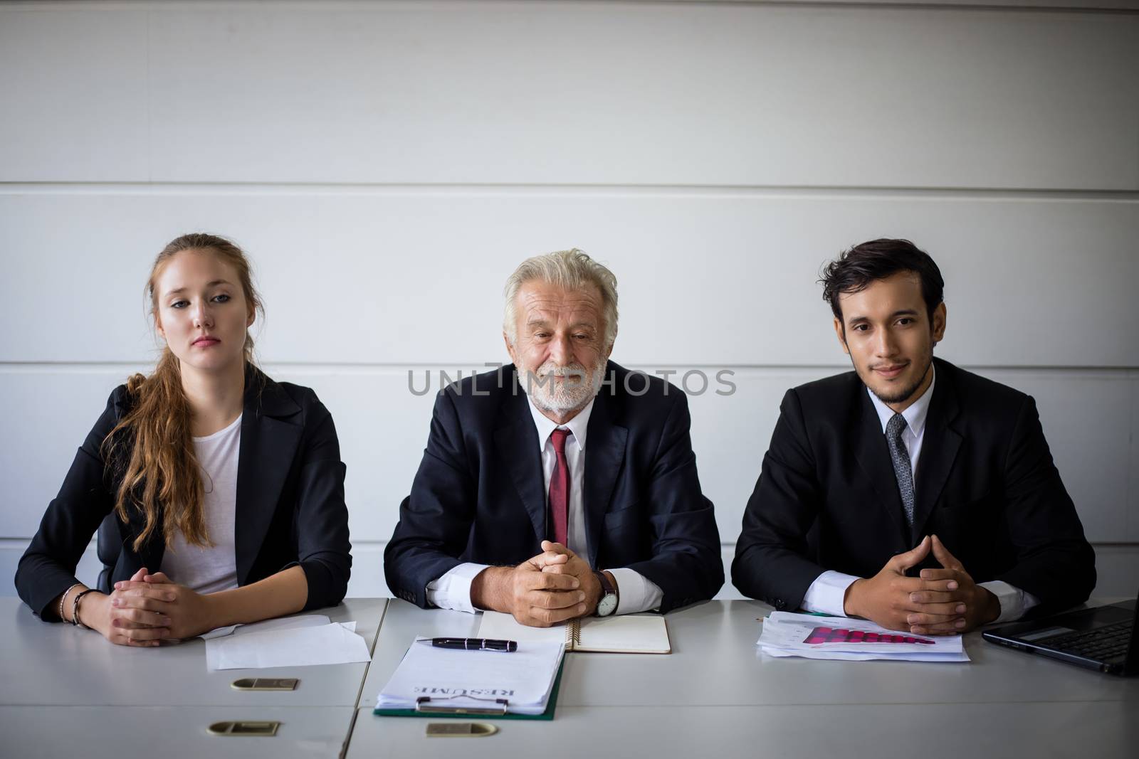 Businessmen and Businesswomen discussing documents for job interview concept