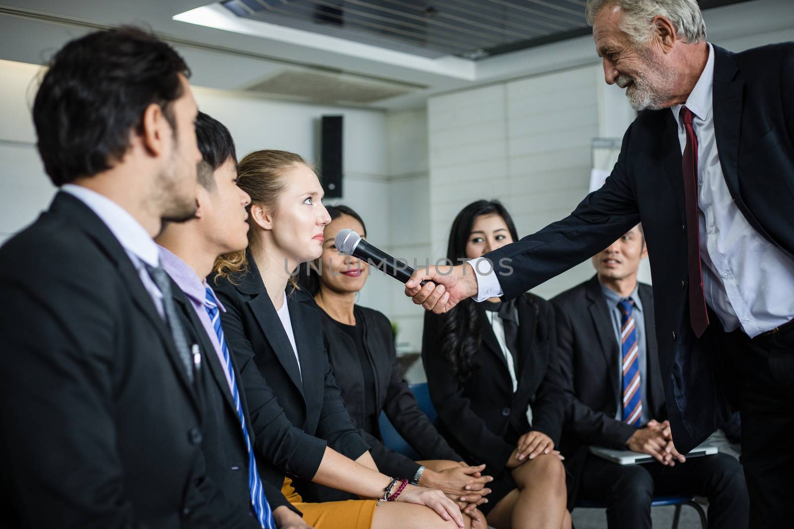 businesswoman is speaking with microphone in training for Opinion with Meeting Leader in Conference Room