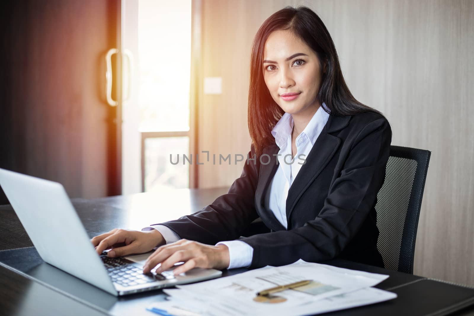 Asian business women using notebook and smiling happy for working