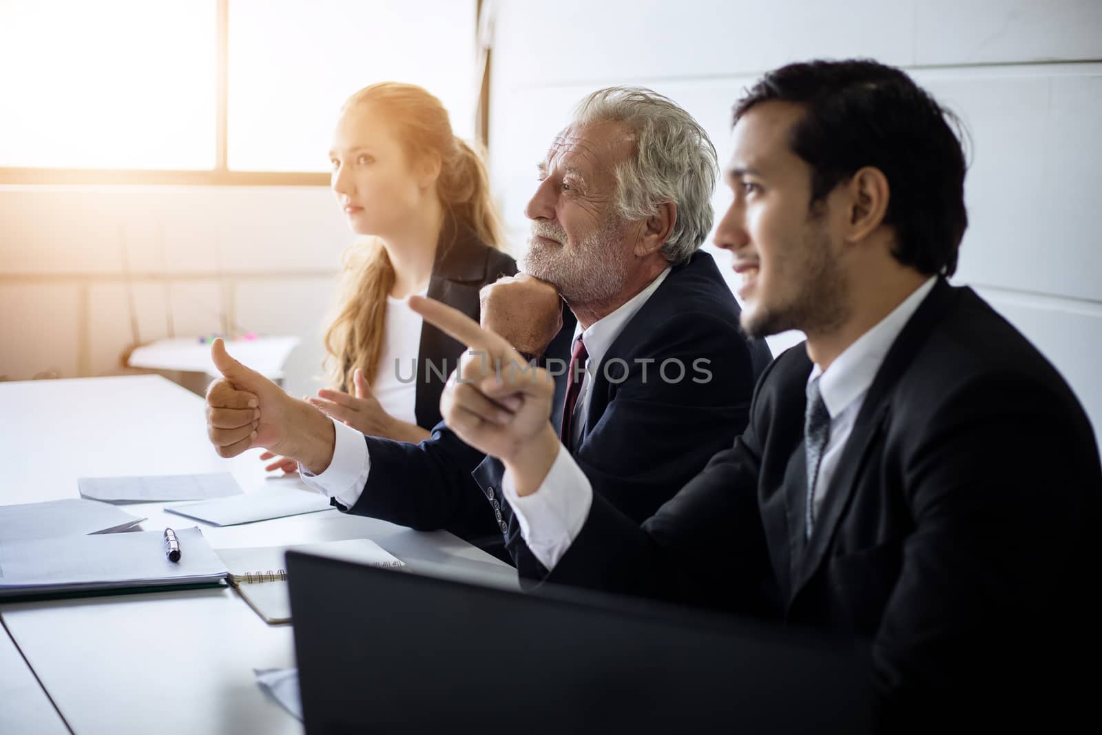 Asian businessmen and group using notebook for business partners discussing documents and ideas at meeting and business women smiling happy for working