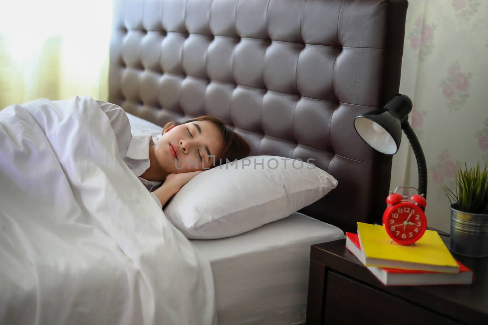  beautiful Asian woman sleeping in white bed. 