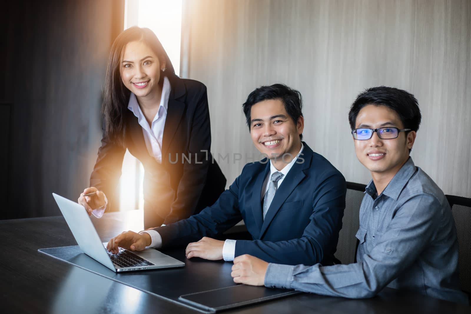 Asian businessmen and group using notebook for business partners discussing documents and ideas at meeting and business women smiling happy for working