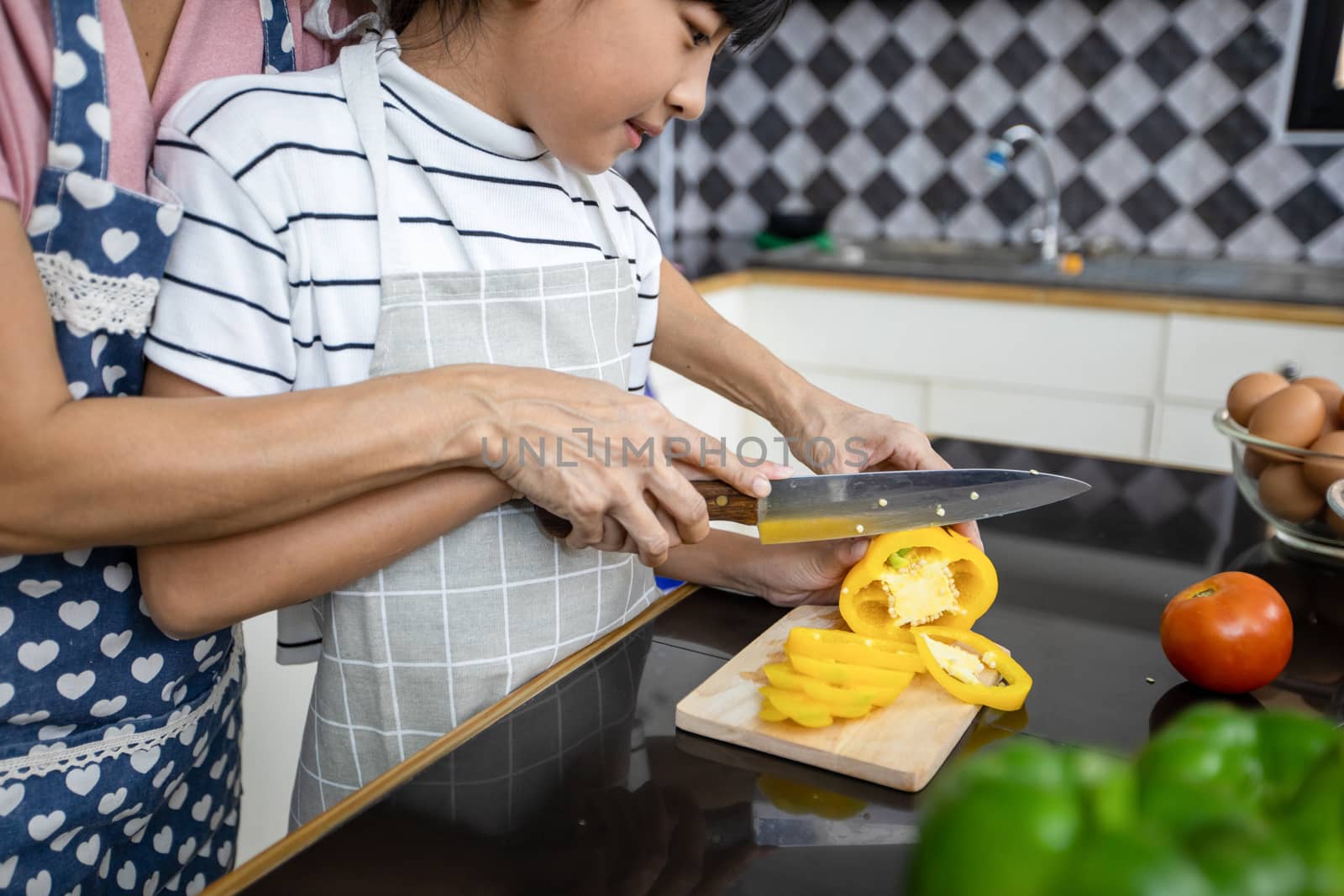 Happy Family have Dad, Mom and their little daughter Cooking Together in the Kitchen