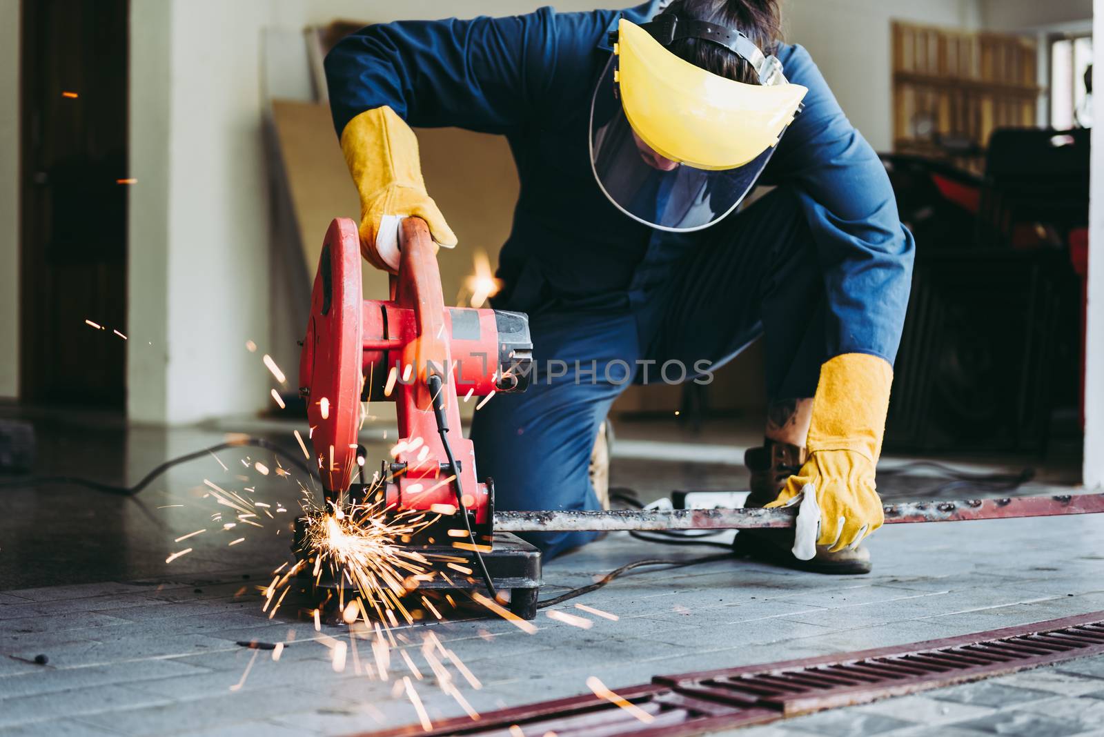 Craftsman Welding is Cutting Steel Work, Welder Man in Safety Protective Equipment Doing Metalwork in Construction Site. Engineering Labor Skill and Workshop Production Concept by MahaHeang245789