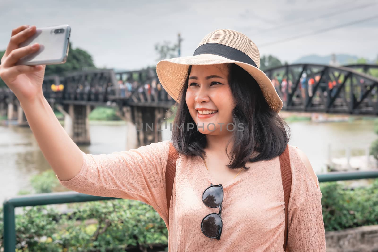 Tourist Woman Having Fun While Sightseeing in Travel Place, Asian Woman Relaxing and Enjoyment While Photographing Landmark of Ancient Architecture in Thailand. Travel Exploring and Journey Concept