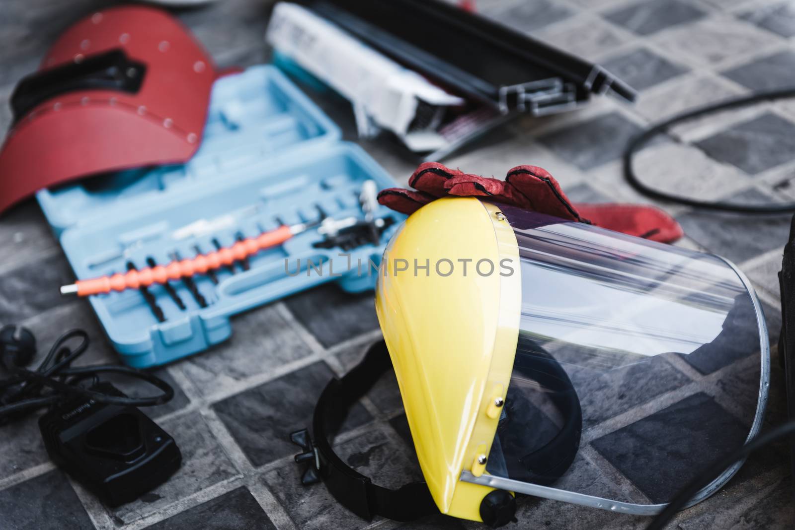 Welding Toolbox and Safety Equipment for Welder Occupation, Hardware Component and Safety Personal Tools. Close-Up of Industrial Instrument Laying on Flooring. Engineering/Labor Concept