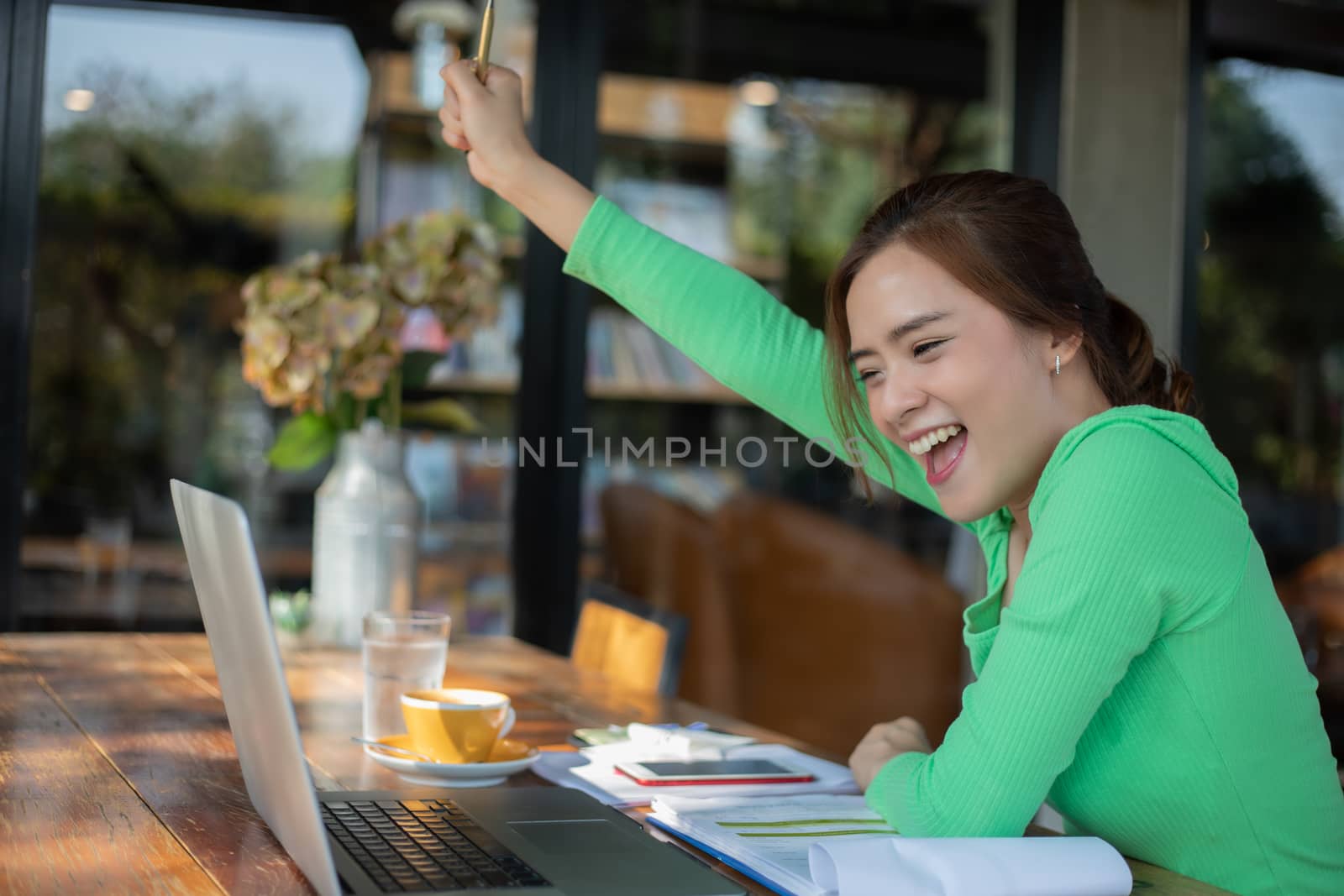 Asian  businesswomen Success and winning concept - happy team with raised up hands celebrating the breakthrough and achievements