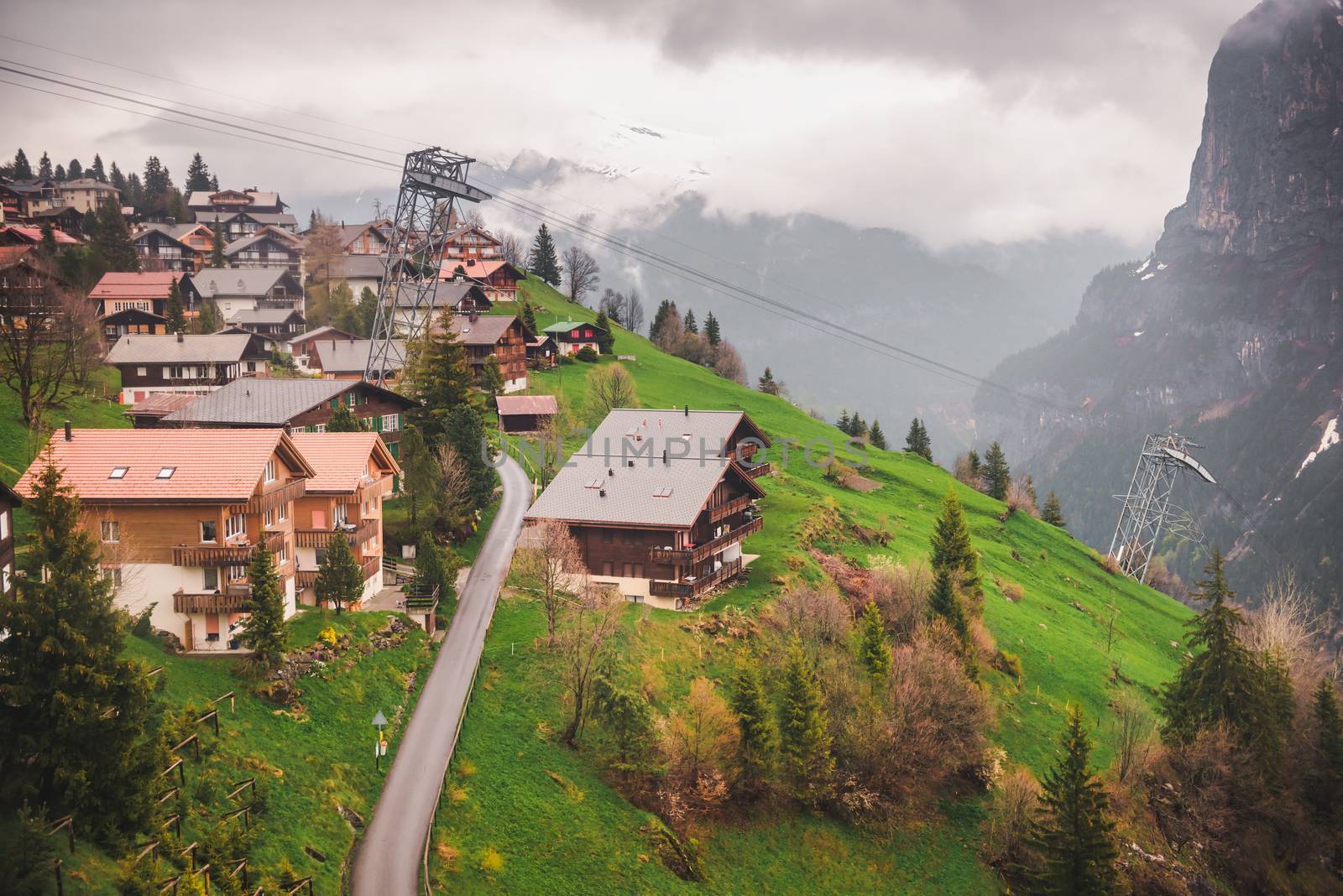 Landscape Scenery Aerial View Over The Village of Murren City From Cable Car, Switzerland. Amazing Valley View With Historic Village Against Swiss Alps at Interlaken Region. Travel Destination by MahaHeang245789