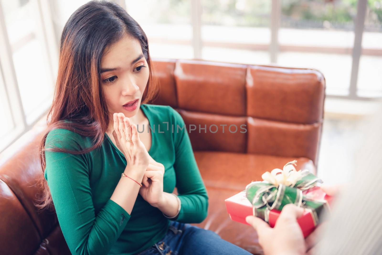 Romantic Surprise and Couple Love Valentine Concept, Young Man is Presenting Surprised to His Girlfriend at Home. Beautiful Woman Having Happiness and Surprise While Her Boyfriend Giving Presents Box. by MahaHeang245789