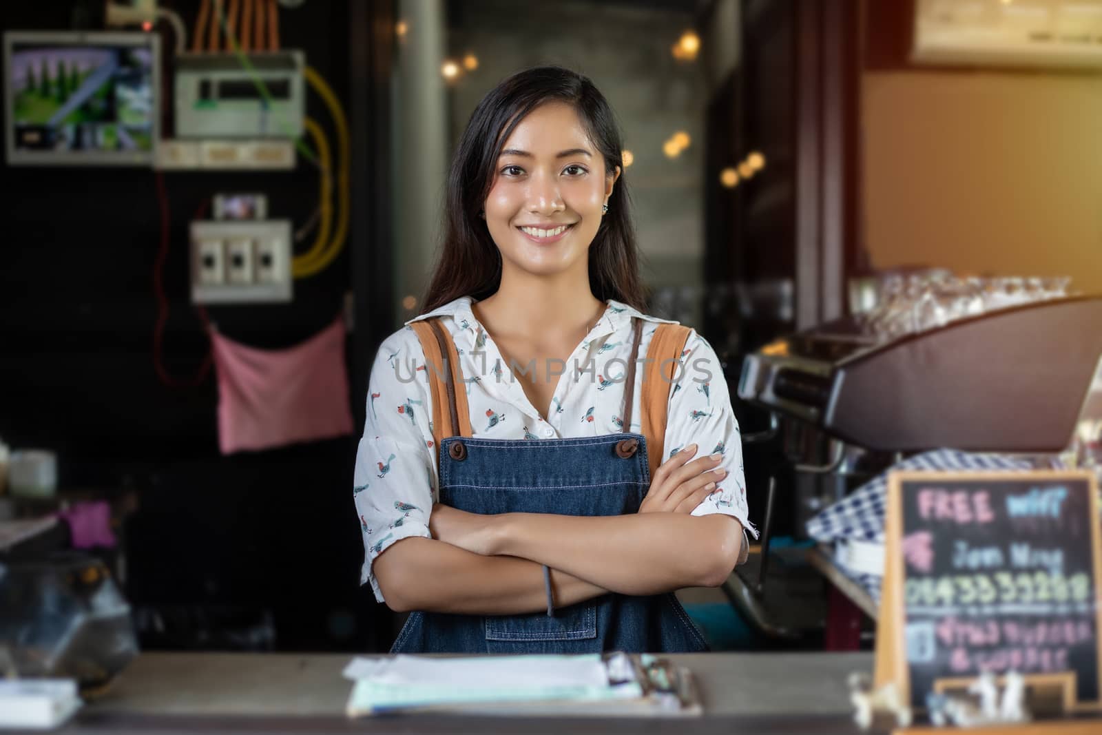 Asian women Barista smiling and using coffee machine in coffee shop counter - Working woman small business owner food and drink cafe concept