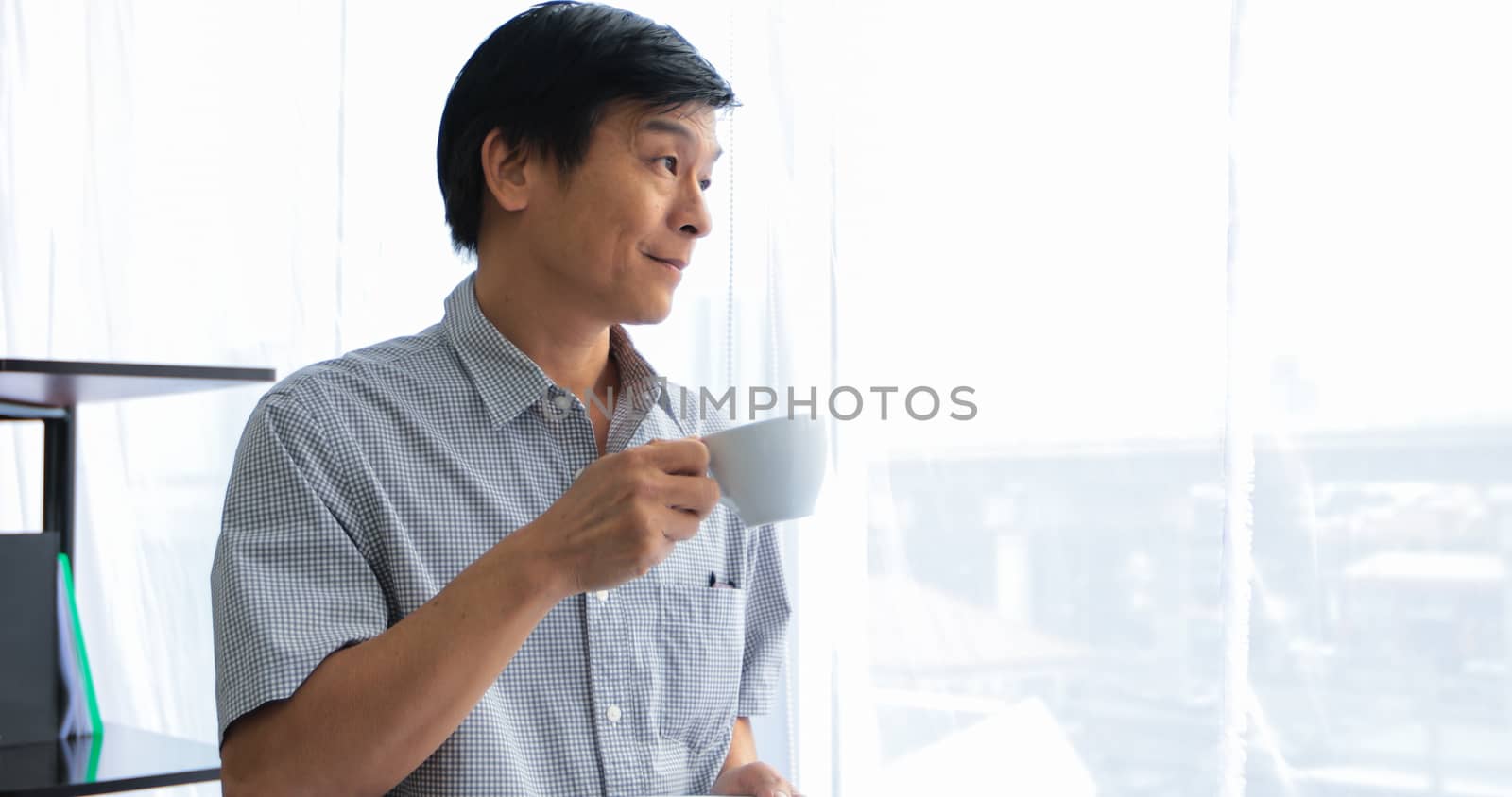 Senior Asian man drinking coffee on relaxing time