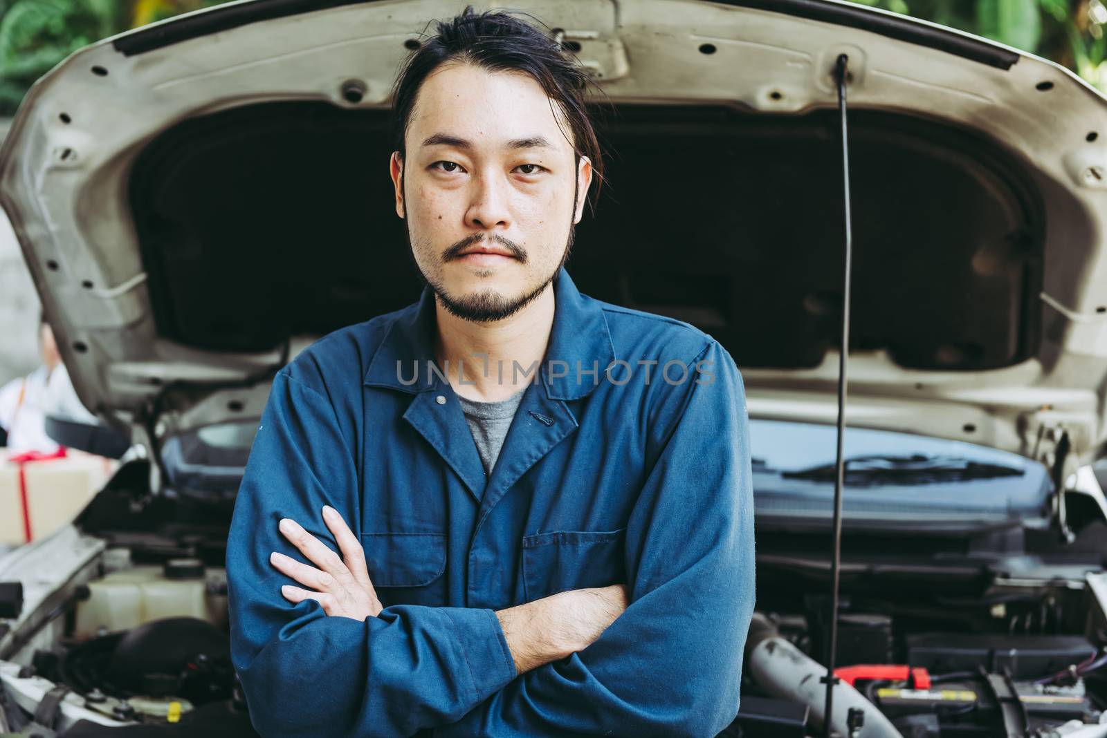 Mechanic Automobile Technician and Jobs Occupation Concept, Portrait Confident Man Technician Vehicle  Automotive Standing Arm Crossed in front of Car Workshop. Mechanical Maintenance by MahaHeang245789