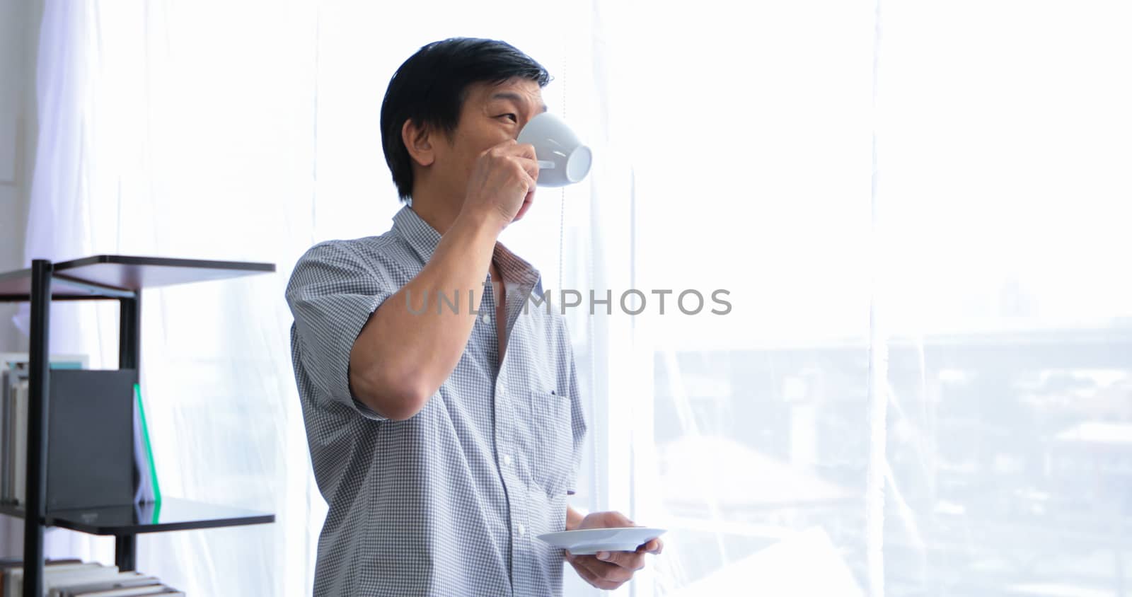 Senior Asian man drinking coffee on relaxing time