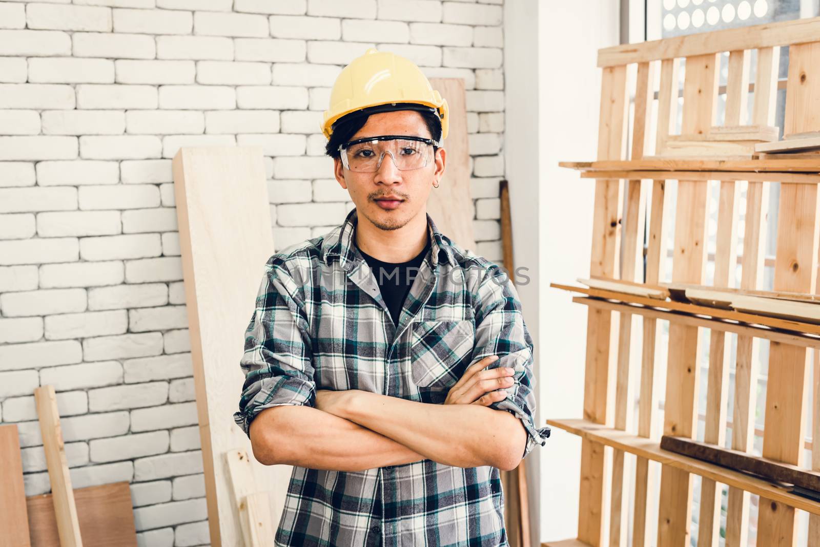 Carpenter Handyman Occupation and Skill Worker Concept, Portrait of Asian Carpentry Man in Personal Safety Equipment Tools Standing Arm Crossed in Workshop Room. Career Workmanship