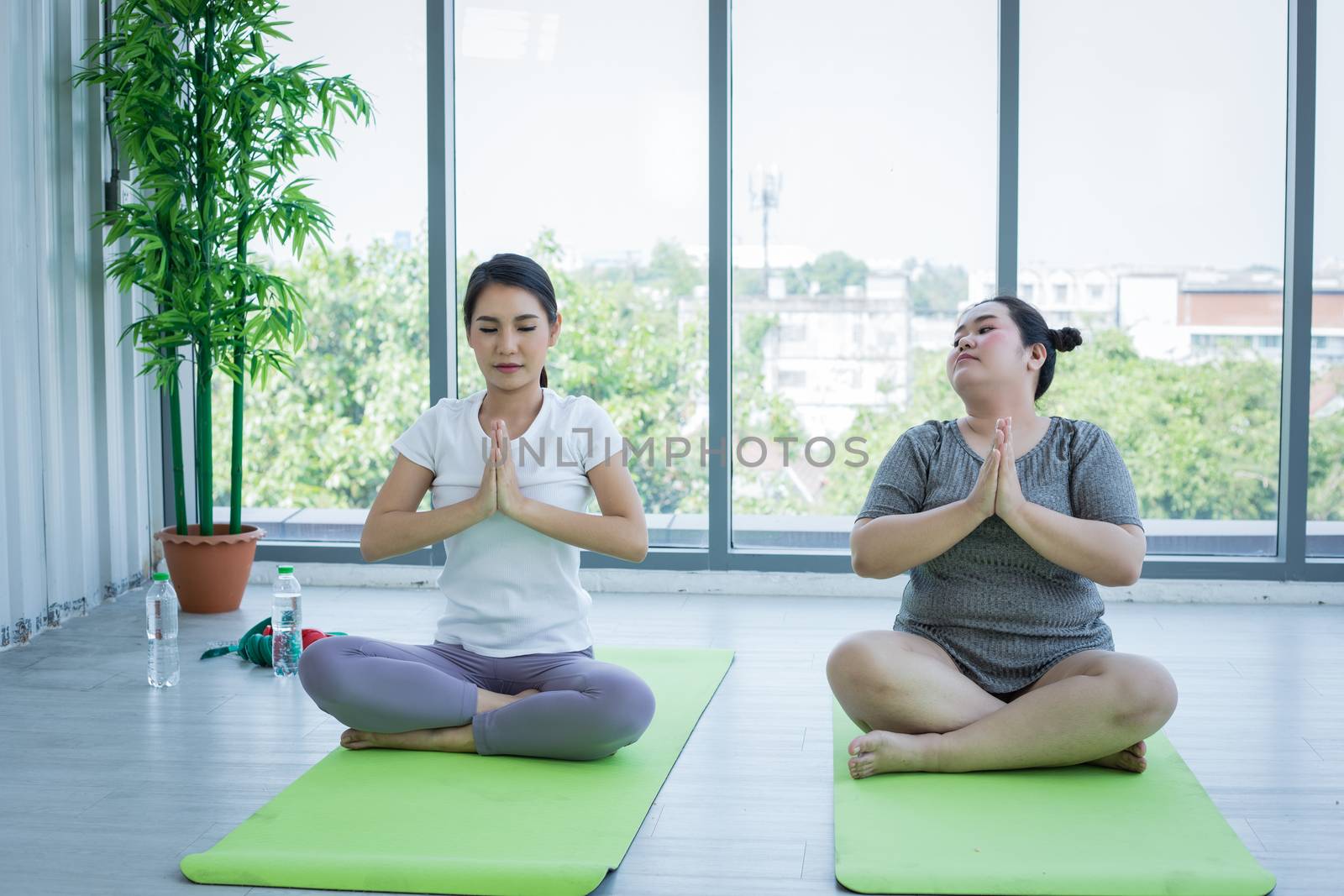 Asian Fat woman and trainer work out in the fitness class and Th by Tuiphotoengineer